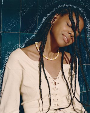 Woman dancing to the sound of Marshall Minor III Burgundy Earbu