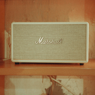 Vintage marshall speaker on a shelf with a retro orange background.
