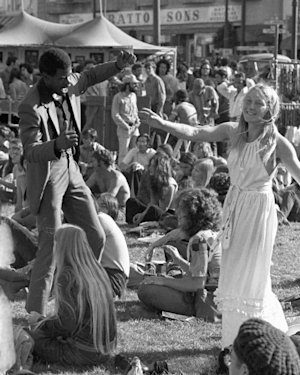 Visitors dancing at a music festival.