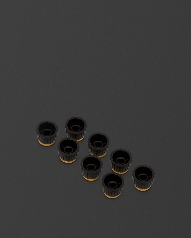 Un grupo de perillas Marshall doradas de potenciómetros D (redondas) sobre una superficie negra.