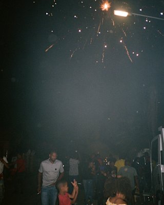 People gathering at night to watch fireworks, a Marshall Patta portable speaker enhancing the experience with music.