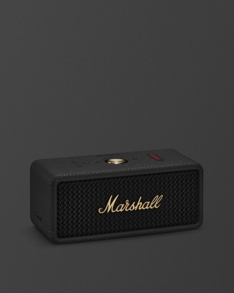 Marshall Emberton III Black and Brass portable Bluetooth speaker against a dark gray background.