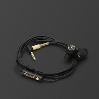 Wired Mode EQ in-ear headphones with microphone in black with brass accents, a 3.5mm audio jack, arranged on a plain dark background.