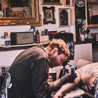 A tattoo artist at the Welcome Studio