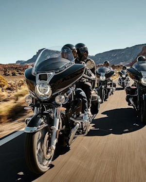 Four BMW R18 Series Marshall edition motorcycles on the road.