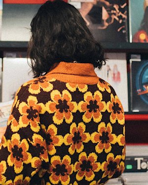 Person looking down at a vinyl from behind)