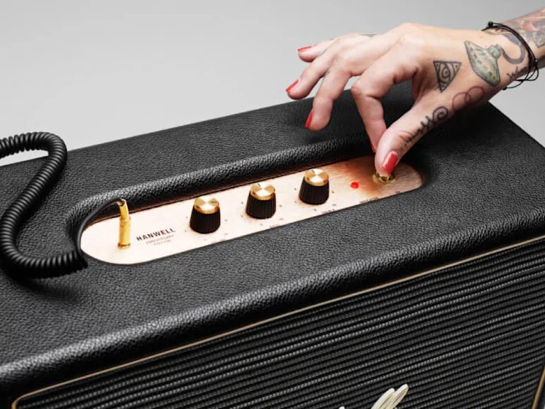An image of a Marshall speaker being passed from one hand to another.