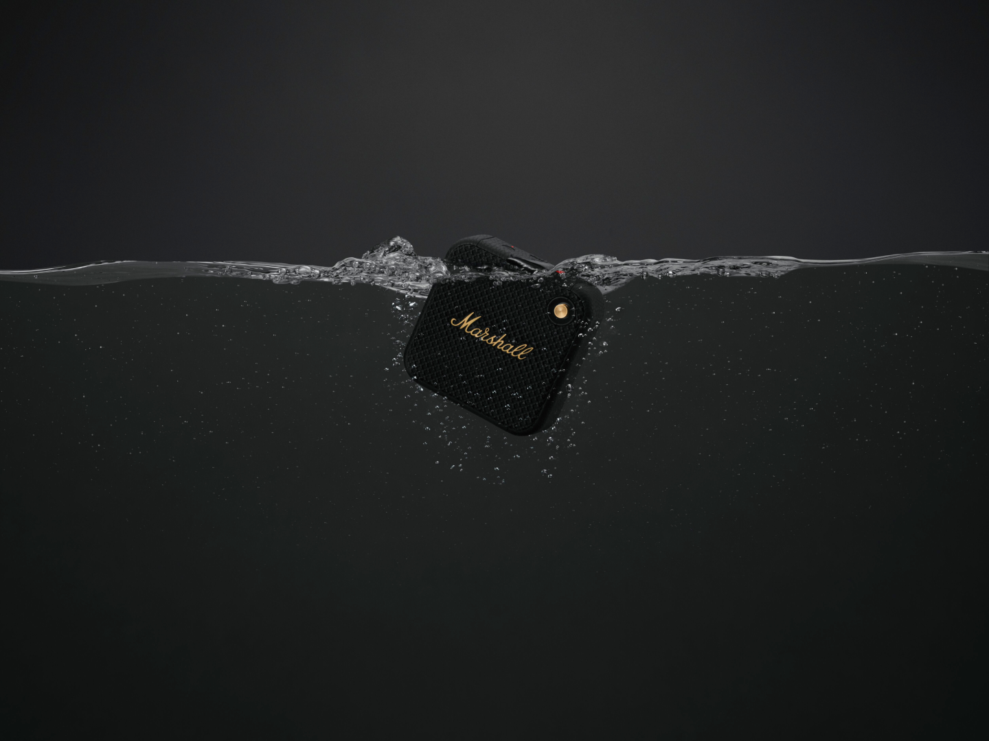 Image of Marshall's WILLEN black & gold droped in water