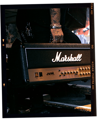 A person carrying a Marshall JVM210 Head