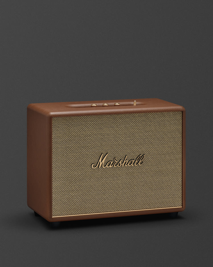 Marshall Woburn III Brown features a textured grill and gold controls on top, displayed against a dark background.