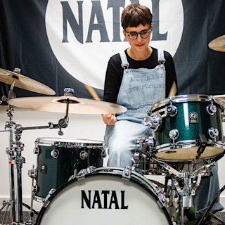 Clara Townsend in a room playing the Natal drums