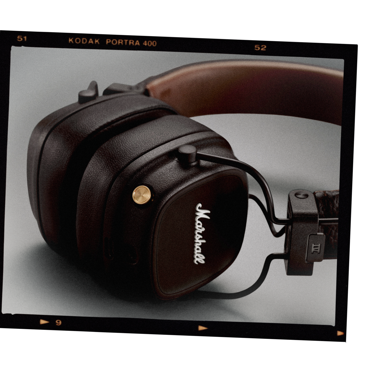 A black and brown pair of Marshall MAJOR IV headphones with a leather strap. 