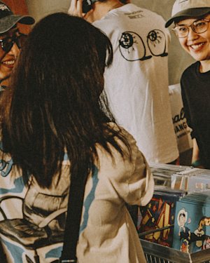 People smiling in a vinyl store)
