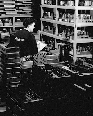 An black and white photo of a man working in a Marshall factory.