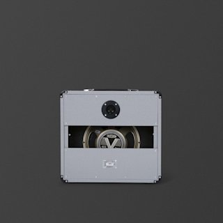 A gray Marshall Studio Jubilee 1x12 guitar amplifier cabinet viewed from the back, showing an exposed Celestion G12 speaker and wiring against a dark background.