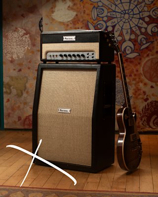 A Marshall ST20H amplifier and guitar sitting on a wooden floor.