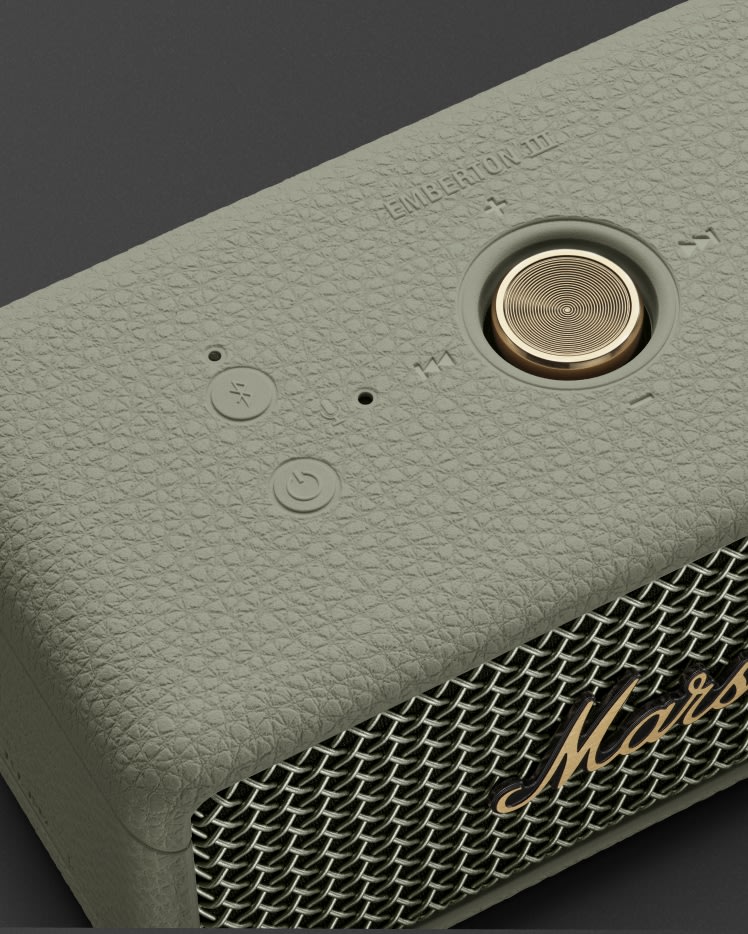 Close-up of the Marshall Emberton III Sage Bluetooth speaker, featuring a classic textured design and a gold control knob.
