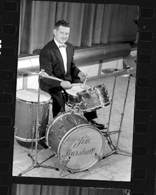 Black and white image of Jim Marshall playing drums