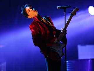 Prince on stage playing guitar
