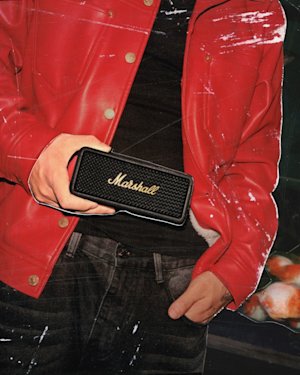 Bohan Phoenix holding Marshall Emberton III Black and Brass bluetooth portable speaker.