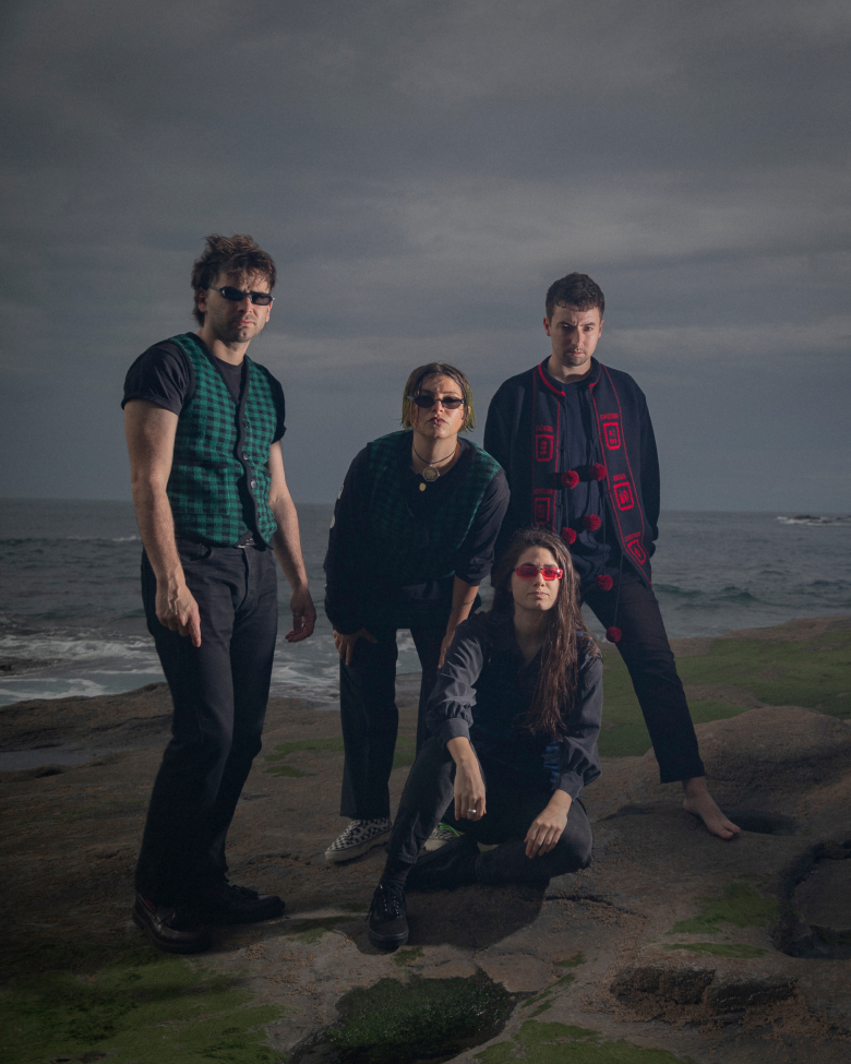 Belako band on beach rock image.