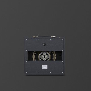 A black Marshall Studio Vintage 1x12 guitar amplifier cabinet viewed from the back, showing an exposed Celestion G12 speaker and a cutout panel against a dark background.