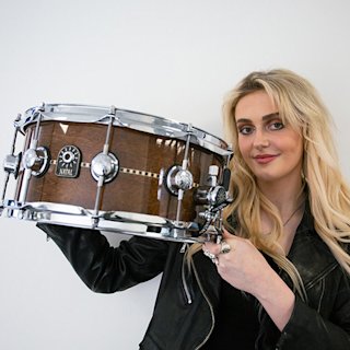 Hattie Steel holding a snare from Natal drums
