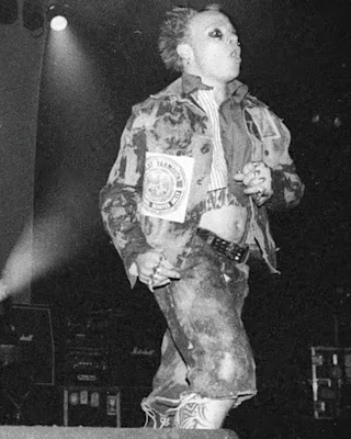 Gif of The Prodigy performing on stage and people in the crowd.