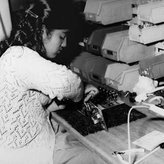 A woman fixing the electronic parts of a Marshall amplifier in 1980