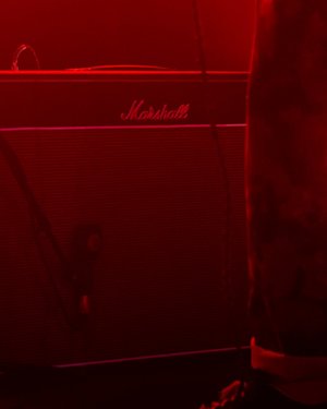 A Marshall Vintage Reissues Amplifier on top of a stage under a red light