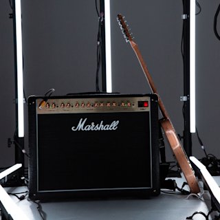 Una imagen del combo Marshall DSL40 con una guitarra apoyada en él