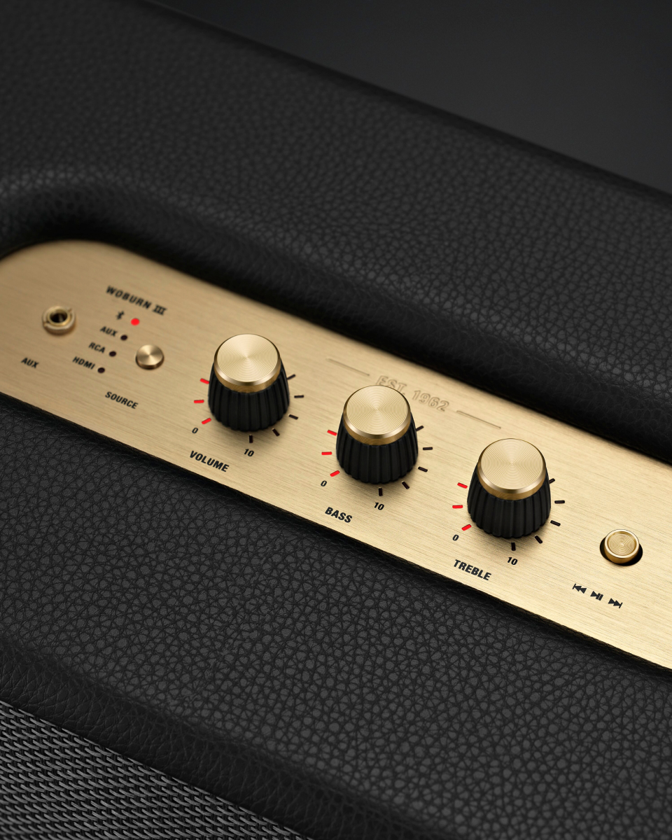 A gold Marshall WOBURN III speaker with a gold knob.