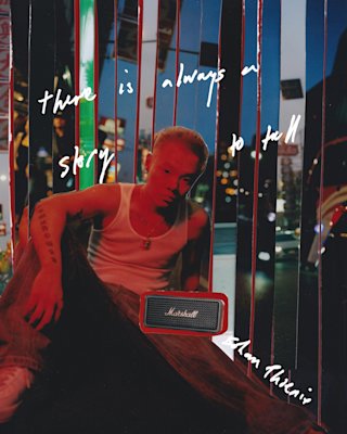 Bohan Phoenix and his Marshall Emberton II Black Portable speaker sitting under a red light.