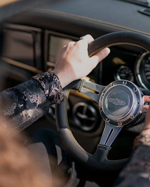 A person driving the Mini Remastered Marshall Edition.