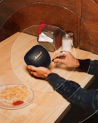 Marshall Monitor III A.N.C. Black en su estuche rígido de alta calidad, en la mesa de un restaurante.