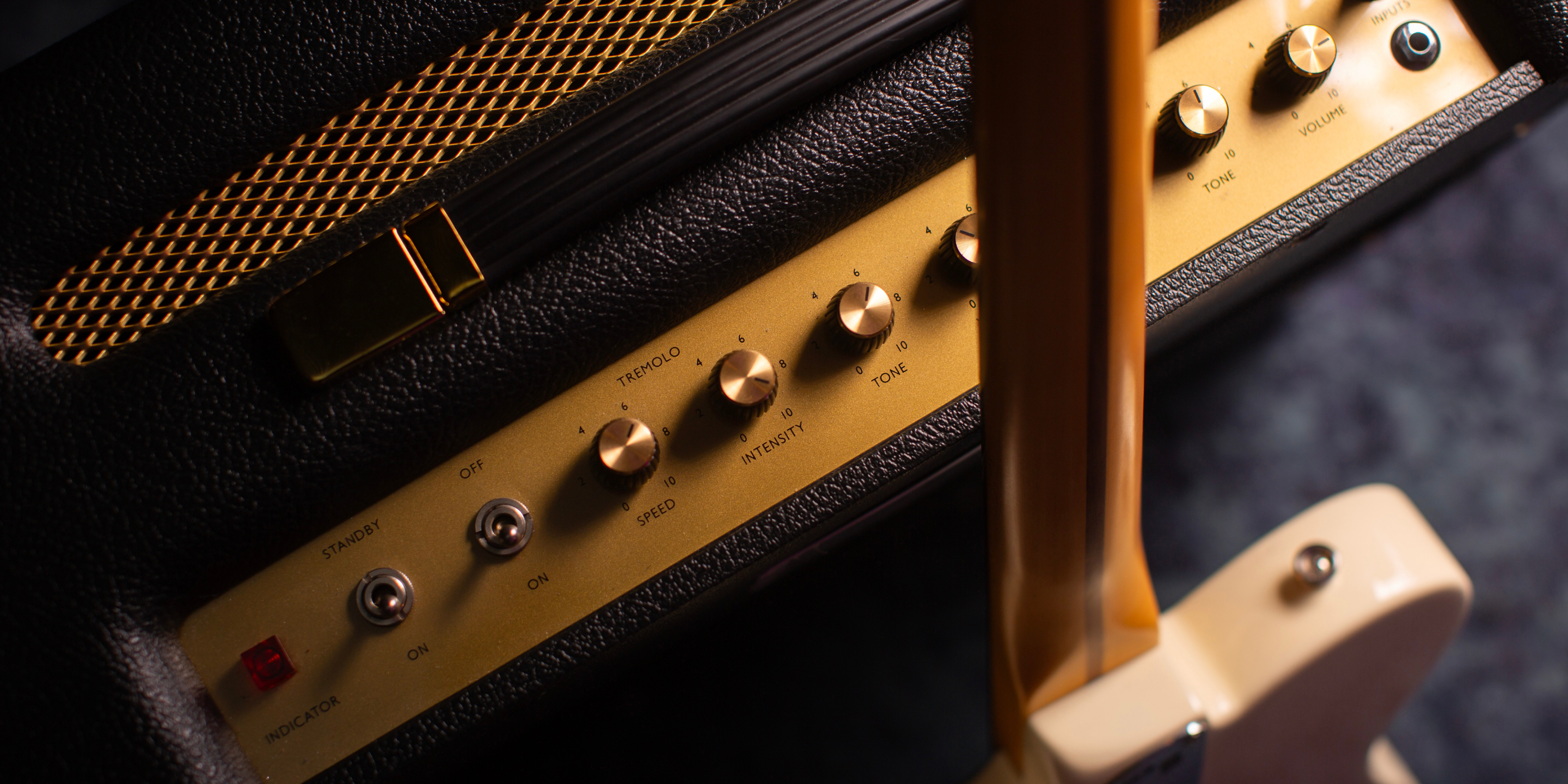 An acoustic guitar standing on the best amplifiers for clean sound. 