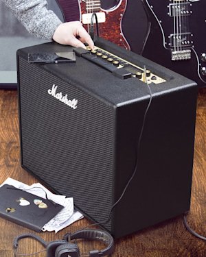 The CODE50 Combo next to a book in a living room