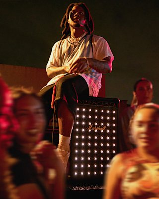 Denzel Curry sat on top of the Marshall party speaker