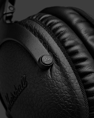 The Active Noise Cancelling (A.N.C.) button on a pair of black Marshall Monitor II A.N.C. Diamond Jubilee headphones.