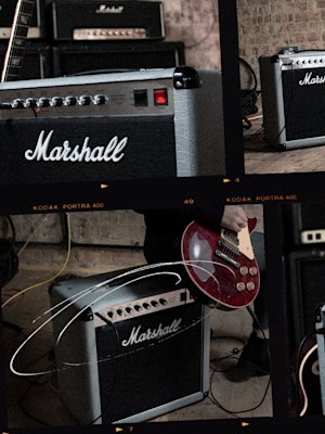 A person playing guitar with a Marshall COMBO 2525C amplifier.