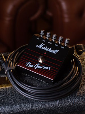 The 'Guv'nor Vintage Reissue Pedal' on top of some cables.