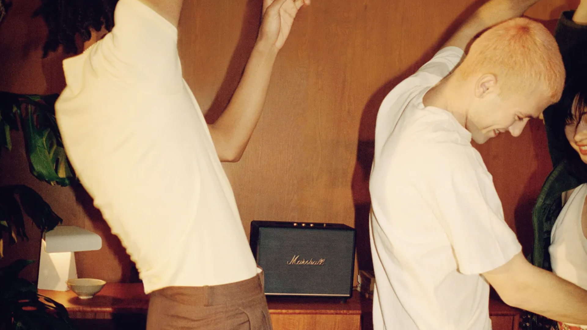 Friends dancing around listening to music coming from Marshall Woburn III Black