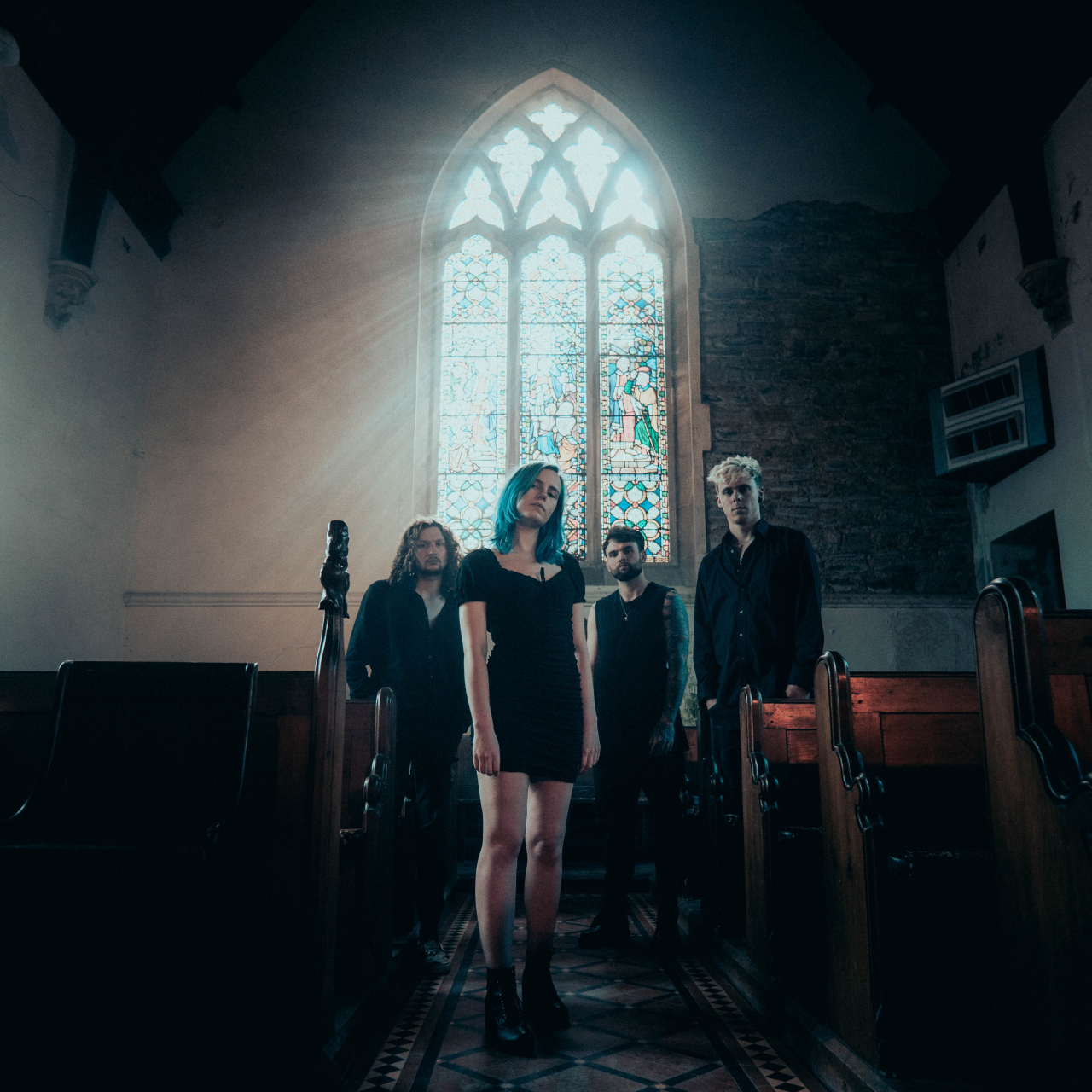Heavy alt rock band Aniimalia standing in a church.