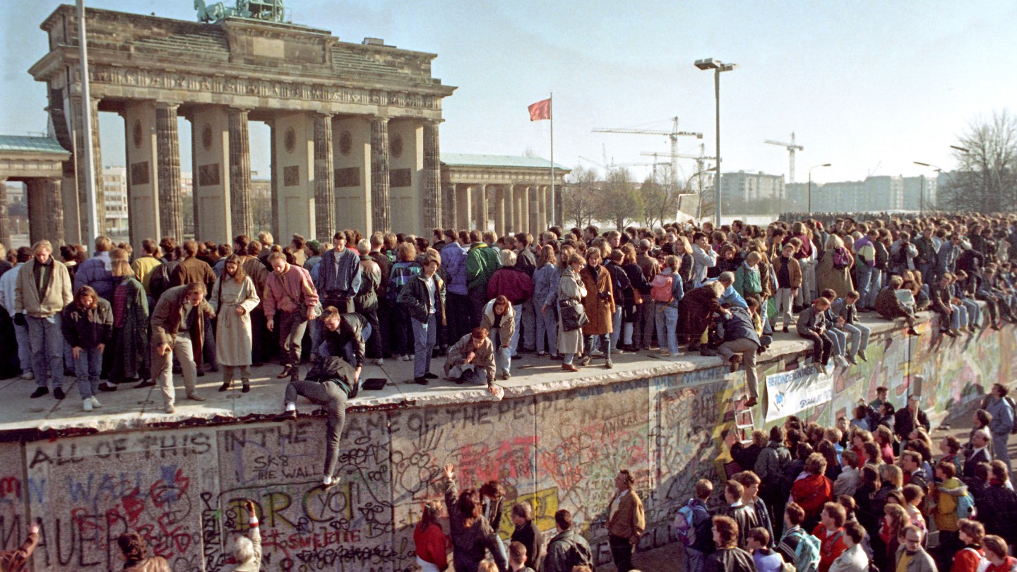Citizens from both sides of Berlin celebrate at the Brandenburg Gate in 1989.