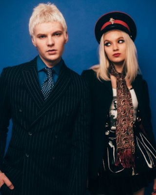 Matt Molotov & Issey Carts posing in front of a blue background