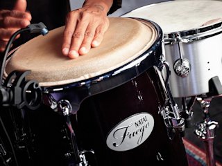 A person plays a Fuego bongo from Natal.