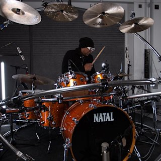 Andy Gangadeen playing music in the Natal drum kit