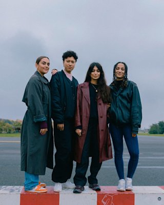 A band posing for a photo in the middle of a field.