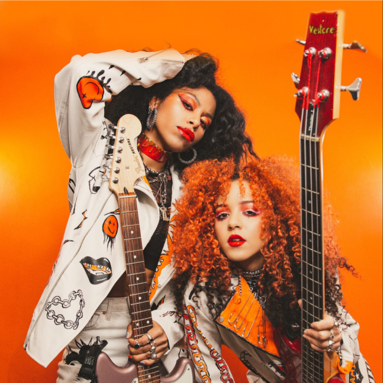 The 'Nova Twins' in front of a orange background.
