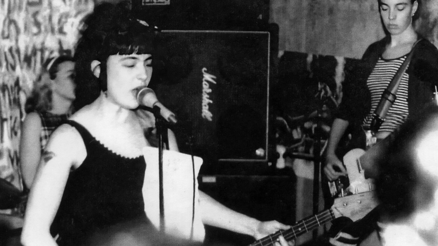Black and white image of one of the first live shows by Bikini Kill.